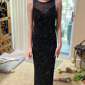 Black beaded formal worn once . Size varies from 4-6 is not stretchy